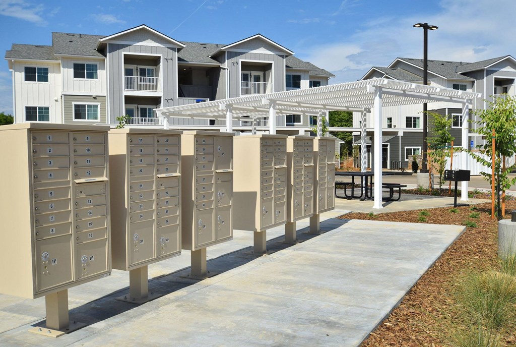 a row of mailboxes in front of an apartment complex