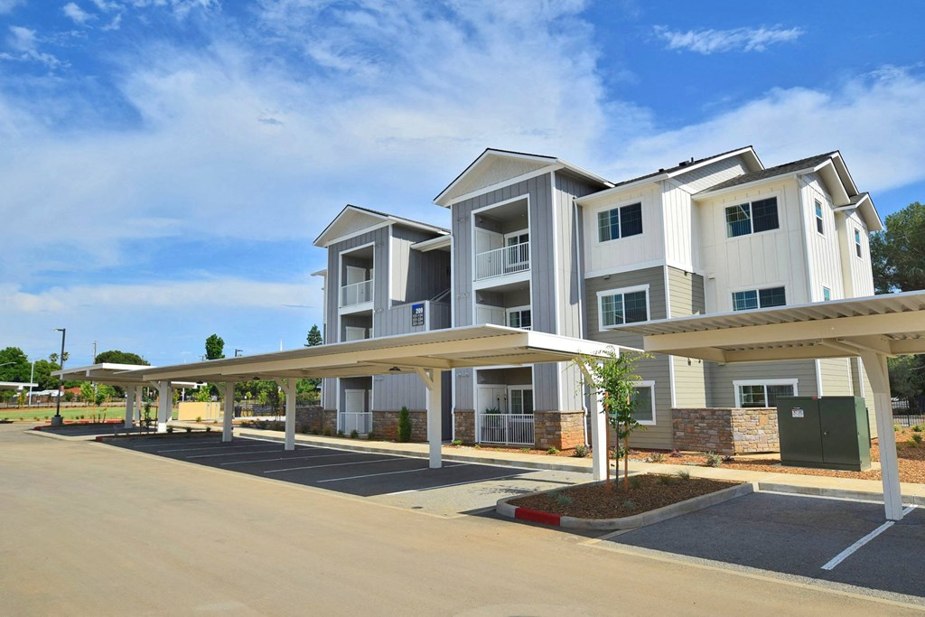a row of apartment buildings with a blue sky in the background