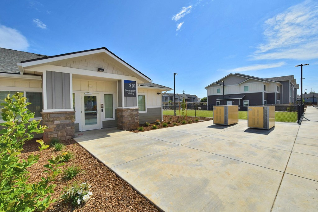 a building with a concrete walkway in front of it