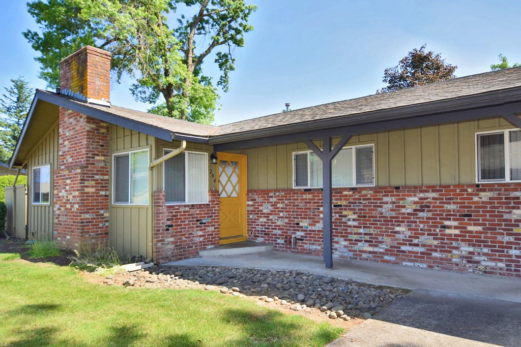 a yellow door on a green house