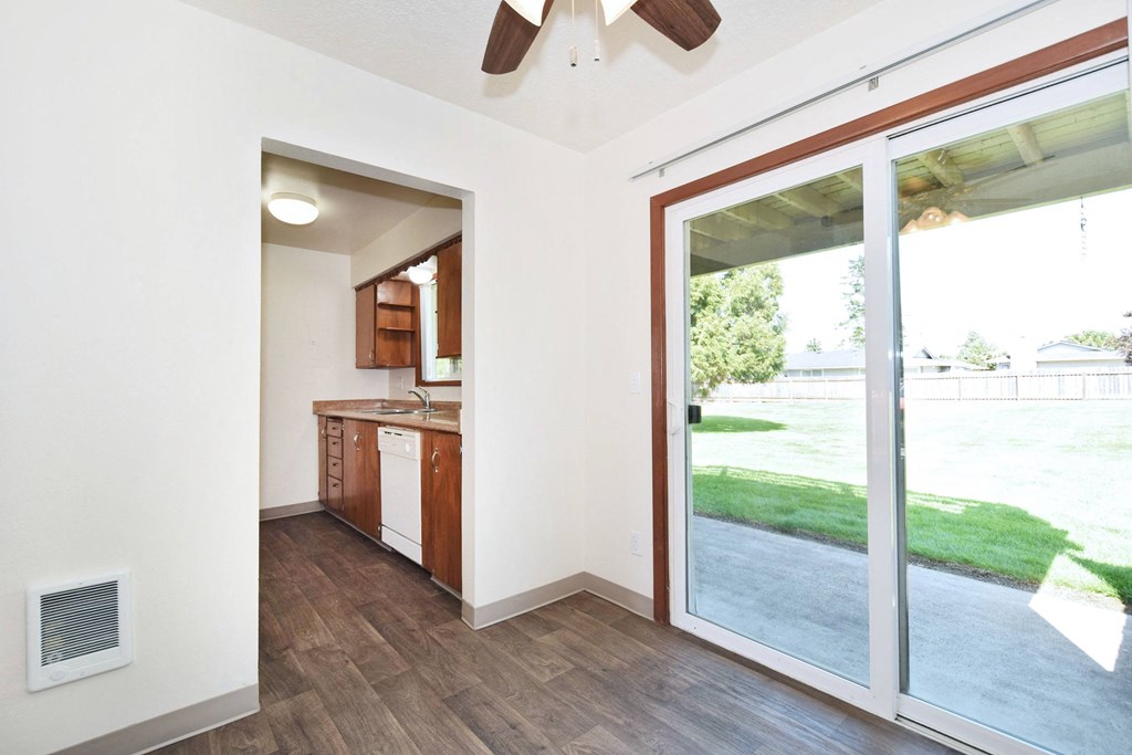 a kitchen and living room with sliding glass doors