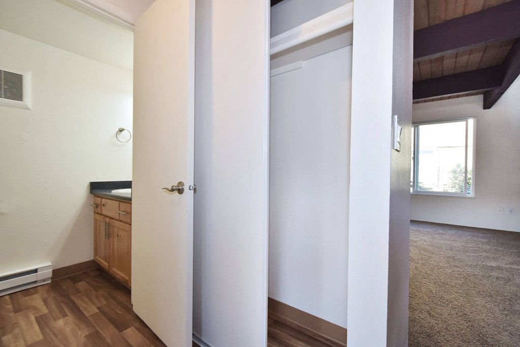 a bedroom with a bed and a mirror