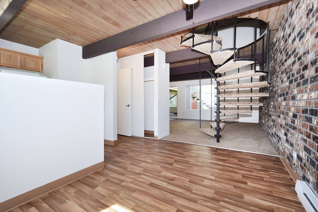 a spiral staircase leads up to the loft