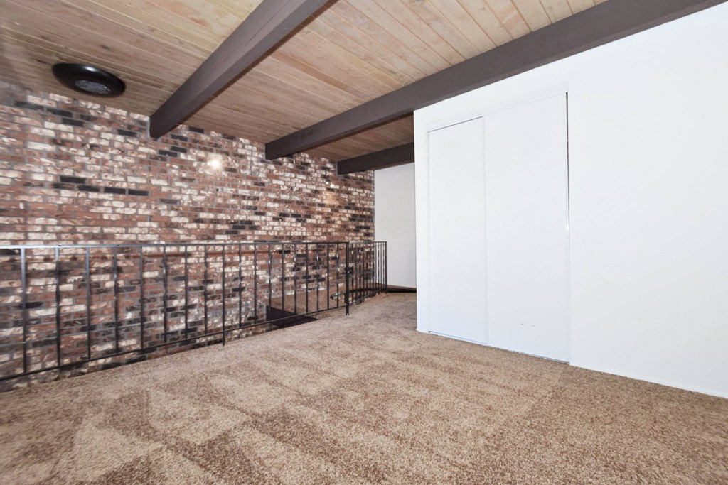 a white walled room with a white door and black wrought iron railings