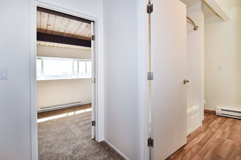 a bedroom with a medium sized bed and a closet with a mirrored door