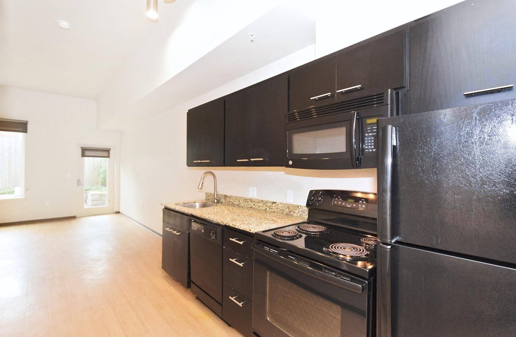 kitchen in a bedroom plus den unit.