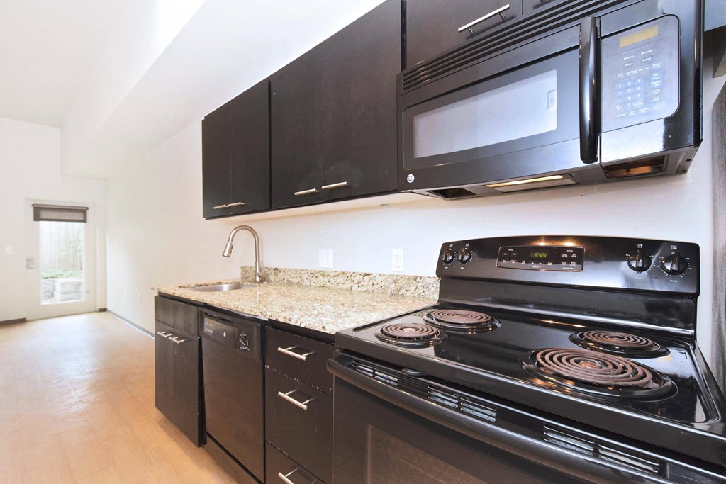 kitchen in a bedroom plus den unit.