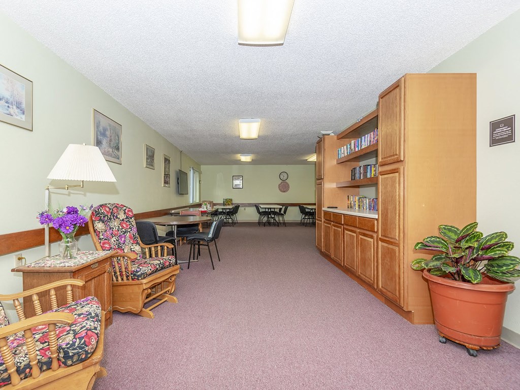 a living room with furniture and a table and chairs