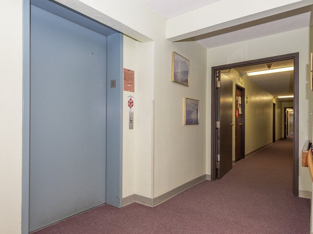 a view of a hallway with a blue door to a room and a hall way