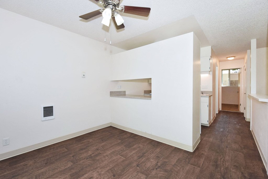 a living room with a ceiling fan and hardwood floors
