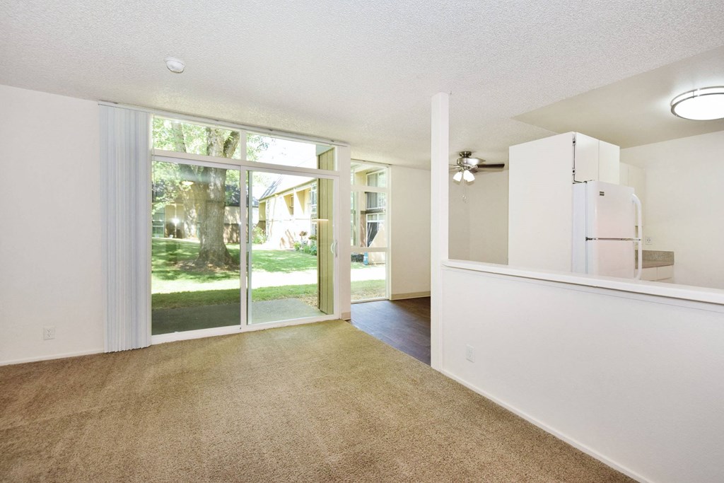 a living room with a white wall and a sliding glass door