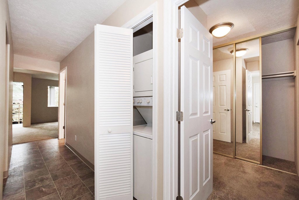 a room with a closet and a mirror