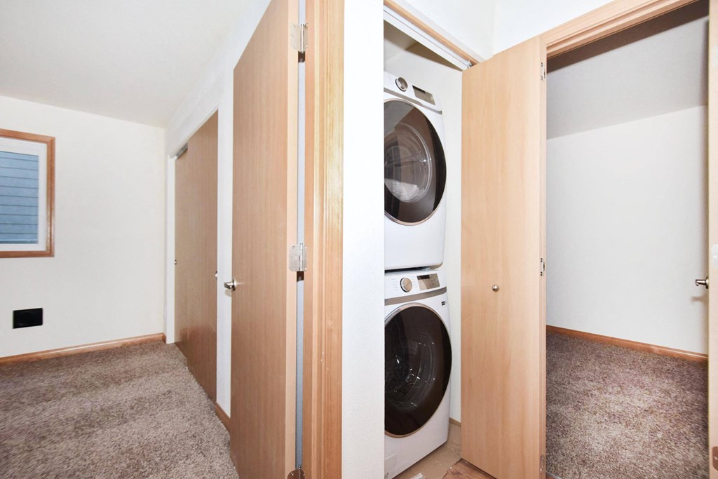 a room with a washing machine and a dryer