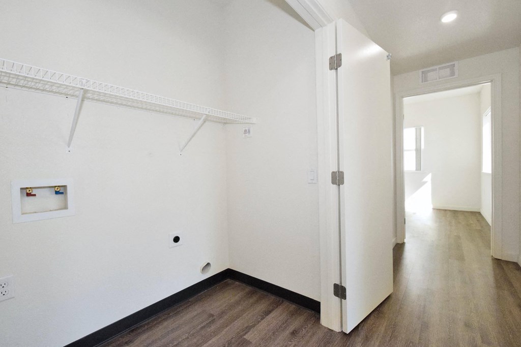 an empty room with white walls and a white door