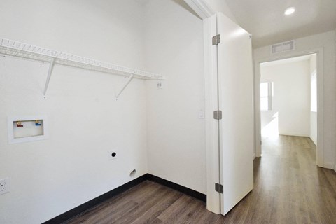 an empty room with white walls and a white door