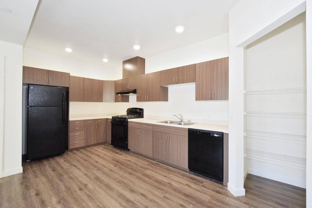 a kitchen with white countertops and black appliances