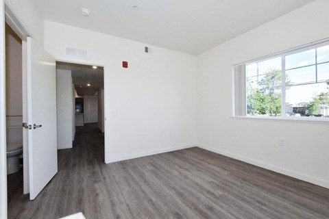 an empty room with white walls and a window
