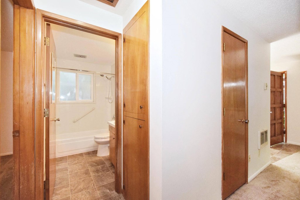 a bedroom with a bed and a mirror