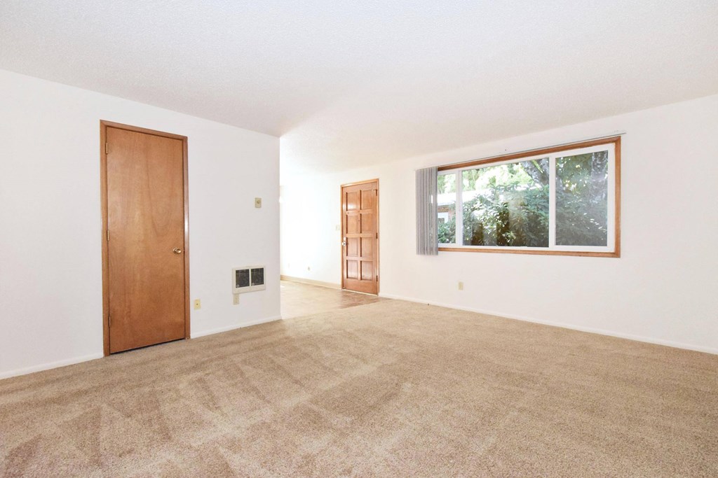 an empty living room with a large window
