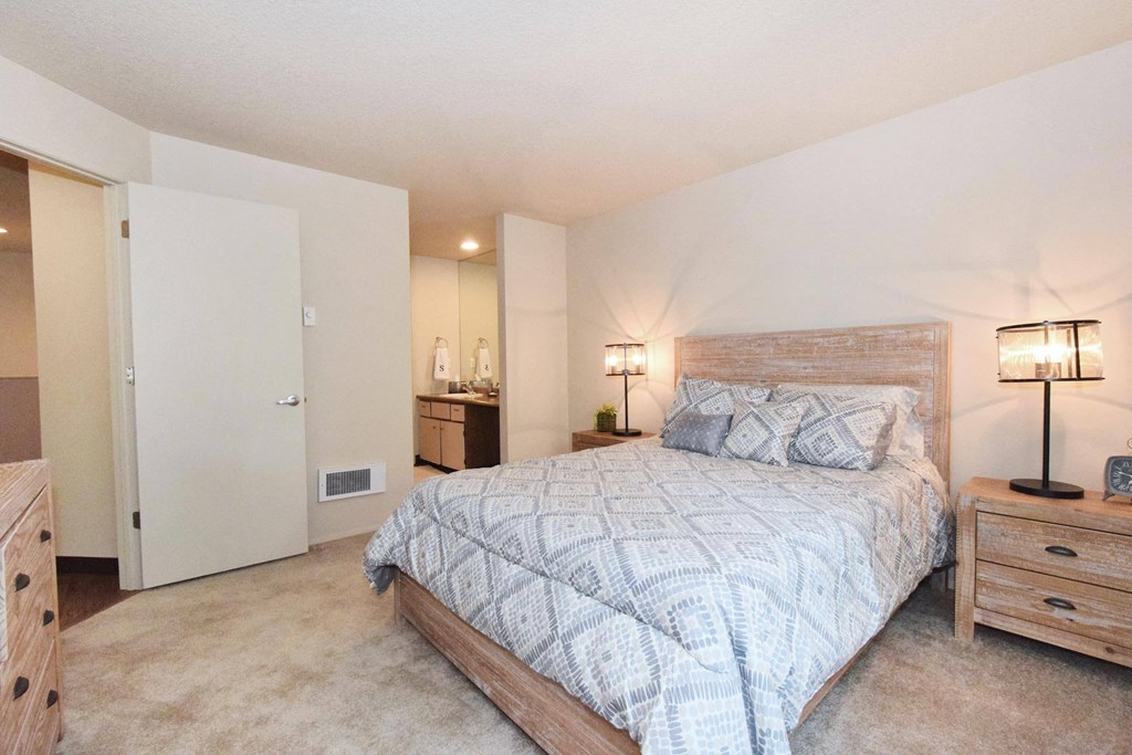 a bedroom with a bed and two night stands