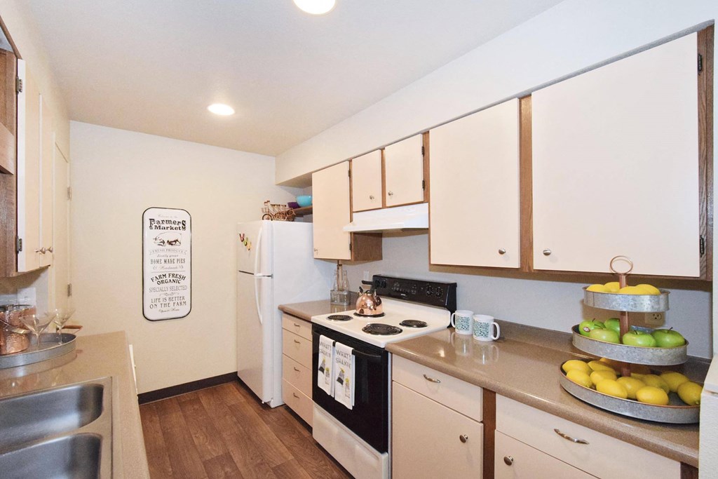 a kitchen with white cabinets and a black stove top oven