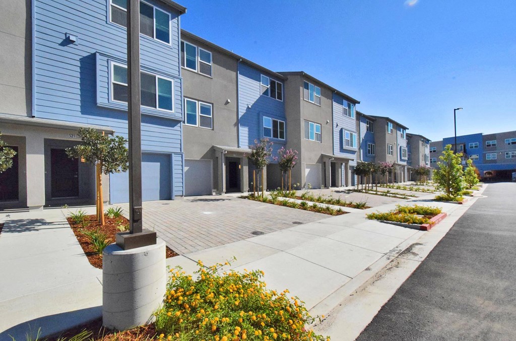 a row of townhomes with blue and white siding