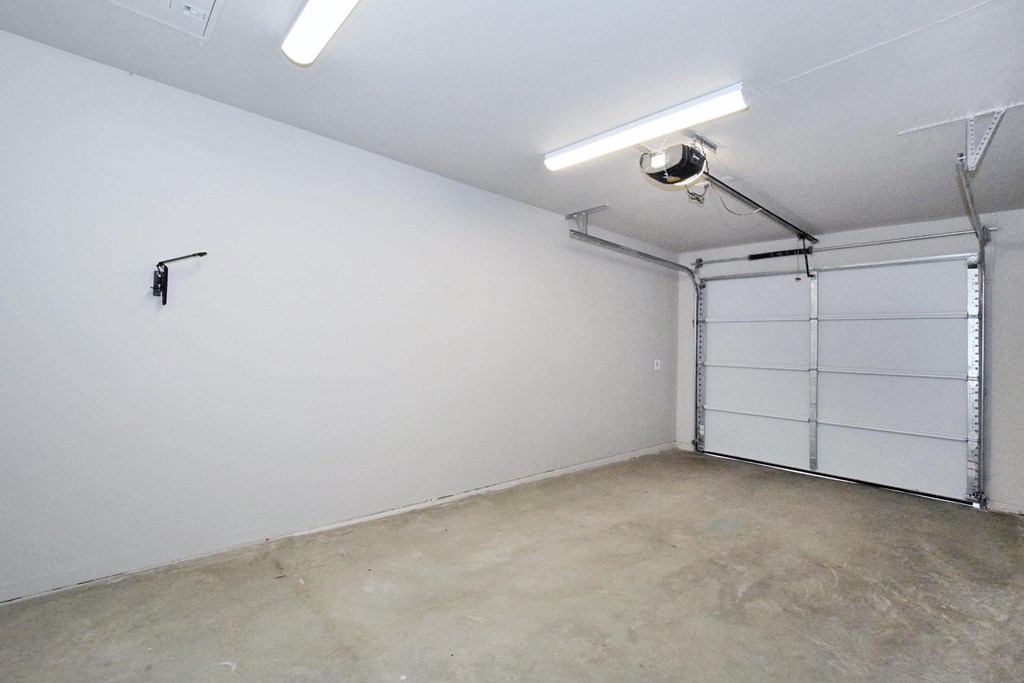 a room with a white wall and a garage door