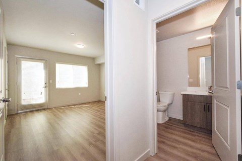 a bedroom with a toilet a sink and a mirror