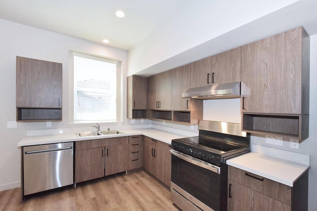 a kitchen with wooden cabinets and stainless steel appliances