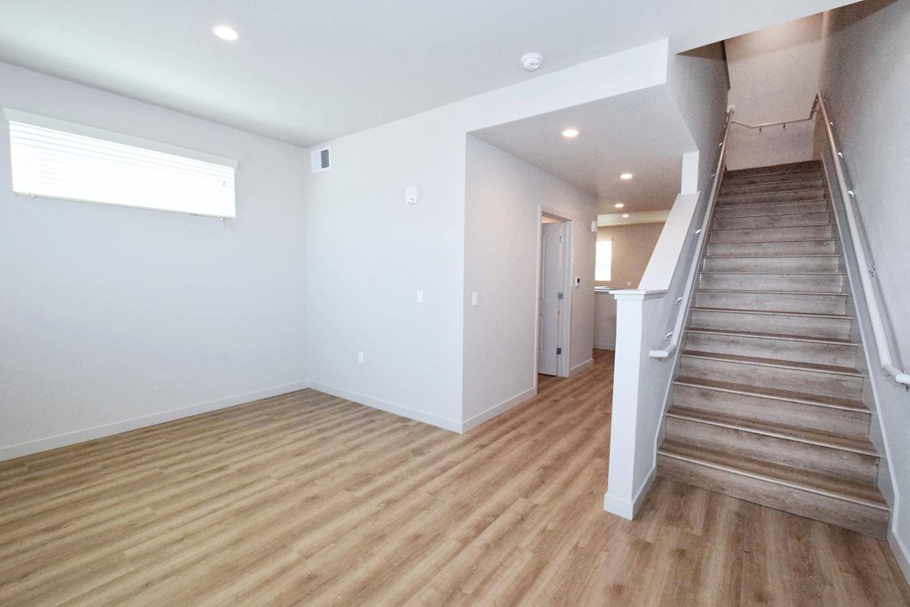 a photo of a living room with white walls and wood floors