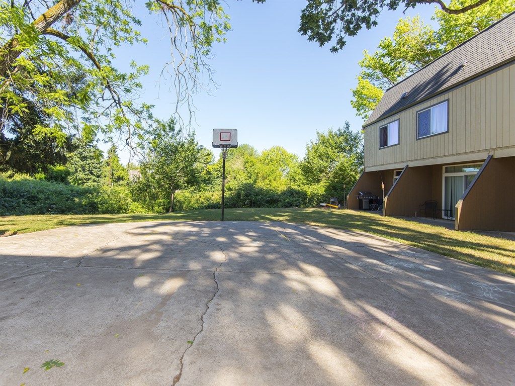 a basketball hoop on the side of a building in a driveway