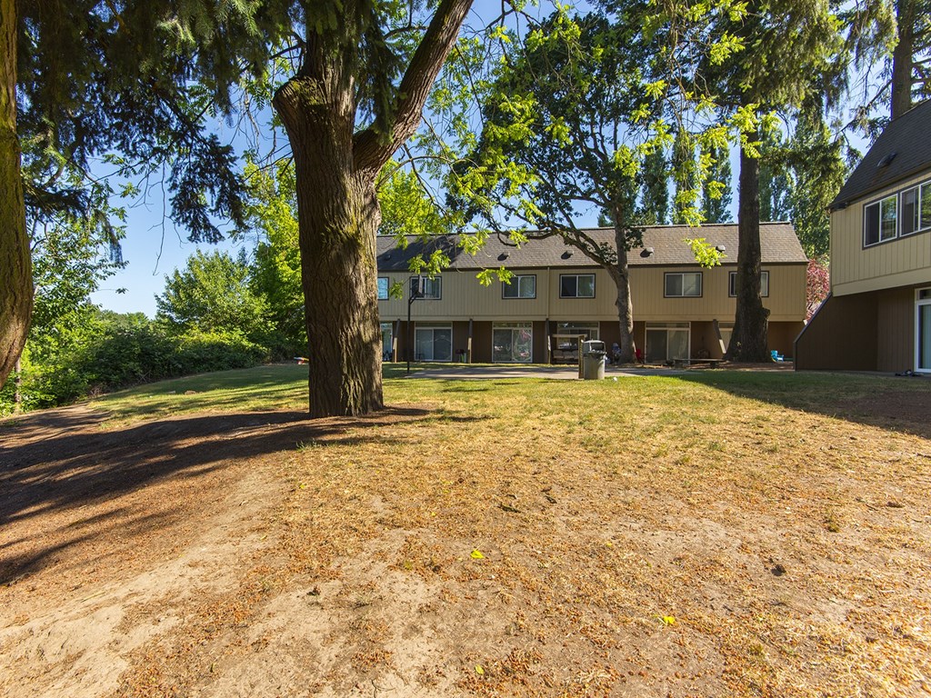 a large yard with a house in the background
