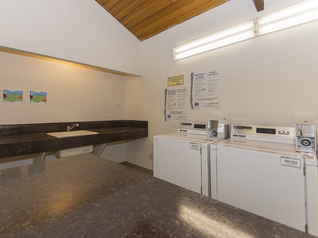 a kitchen with two washes and a sink and a refrigerator