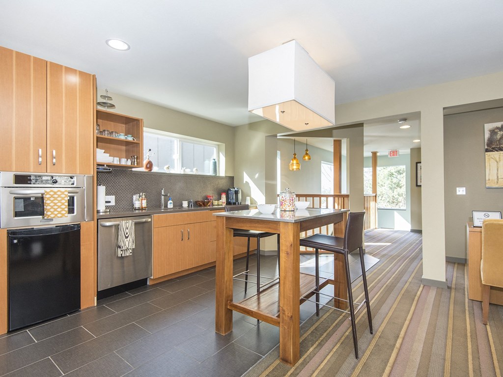 a kitchen with a large island and a table with chairs