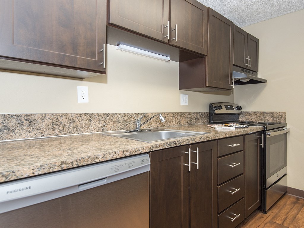 a kitchen with stainless steel appliances and granite counter tops