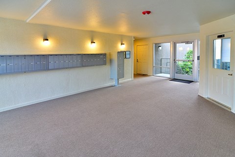 an empty living room with a door to a balcony