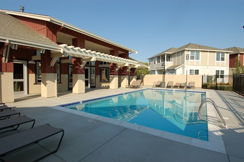 a swimming pool with a building in the background