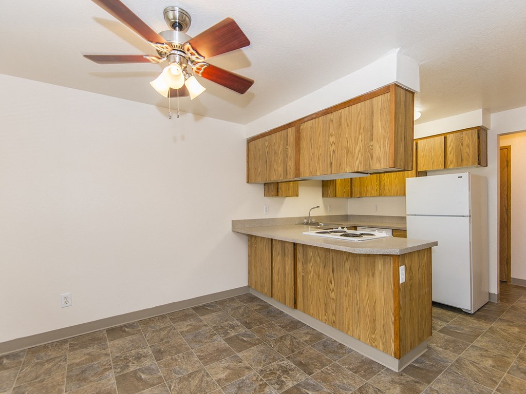 Willow Creek:  a kitchen with wooden cabinets and a ceiling fan