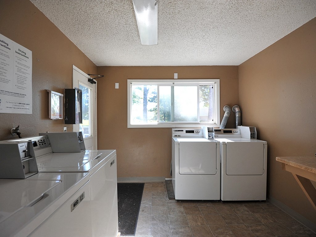 a kitchen with a washer and dryer and a window