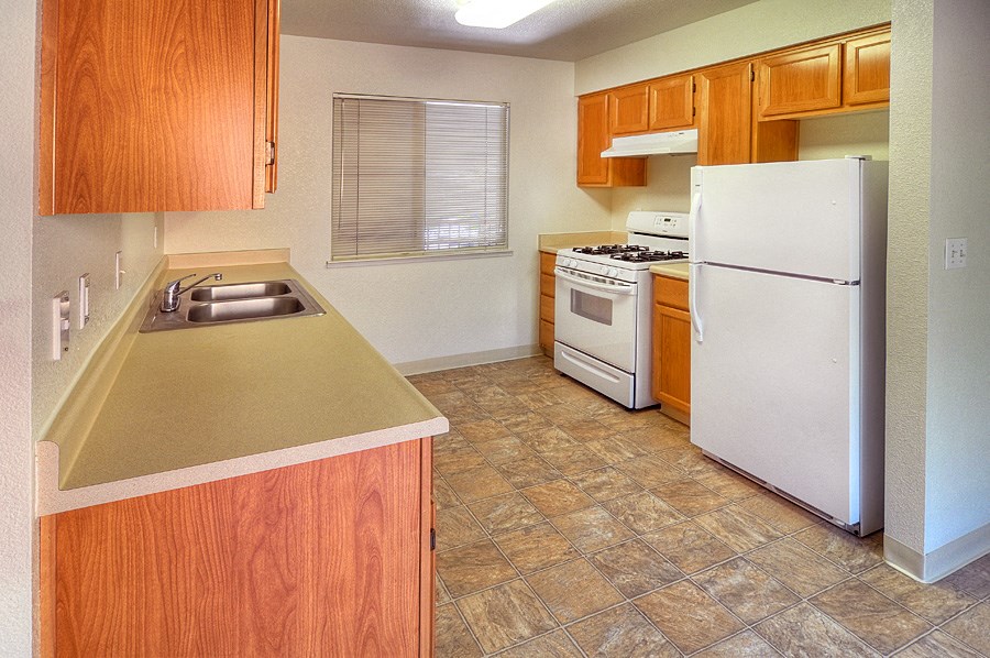 a kitchen with a sink and a refrigerator