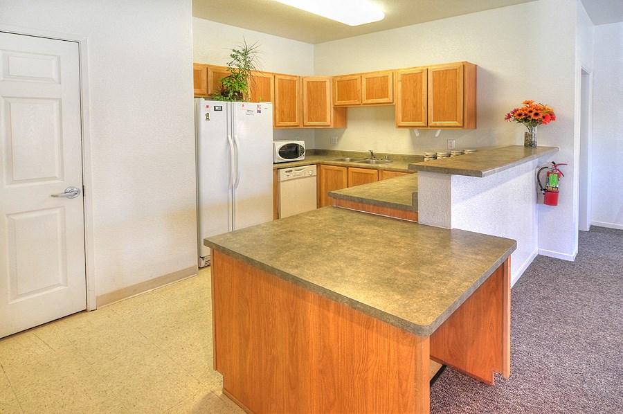 a kitchen with a counter top and a refrigerator