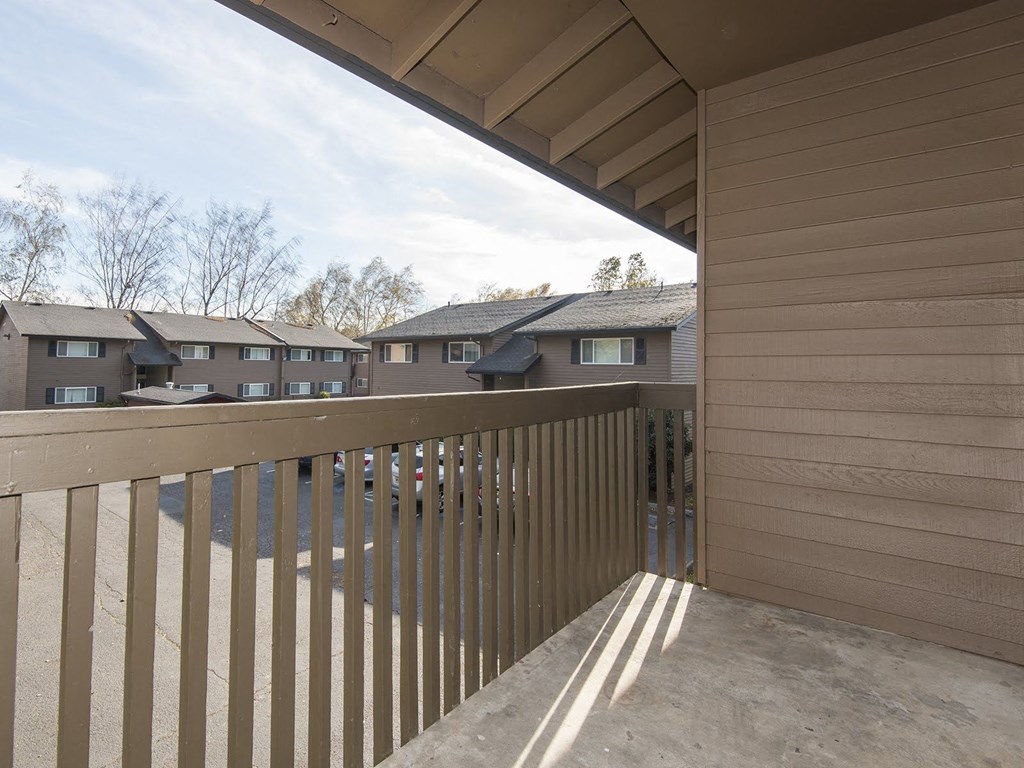 the view from the balcony of a house with a wooden fence