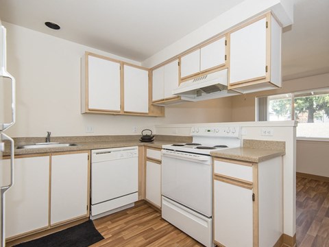 a kitchen with white appliances and white cabinets