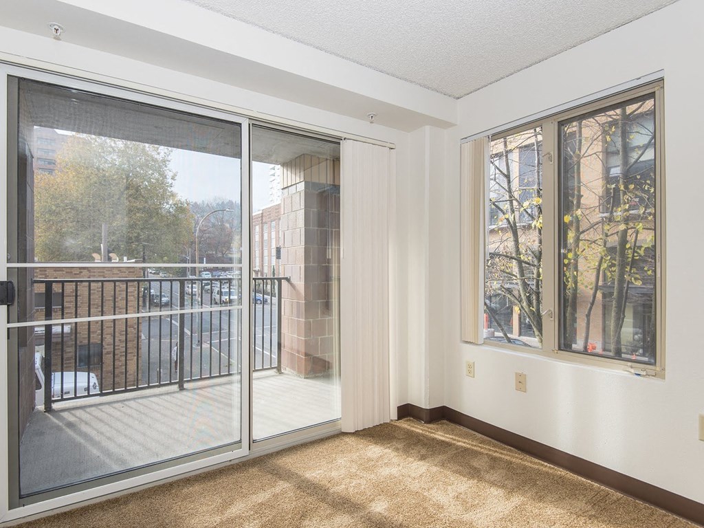 a living room with a balcony and a sliding glass door