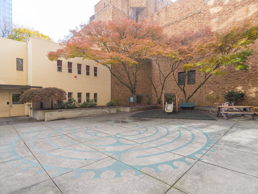 the outside of a building with a labyrinth on the ground