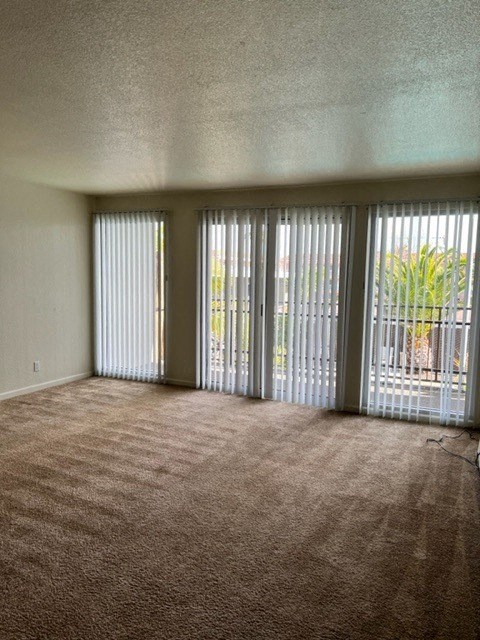 an empty living room with sliding glass doors