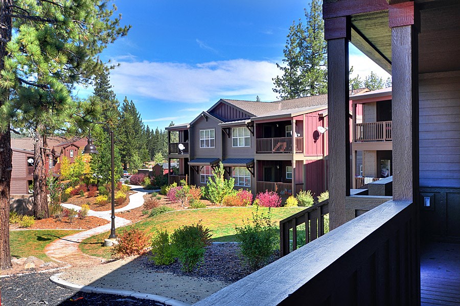 a view of the neighborhood from the balcony of an apartment building