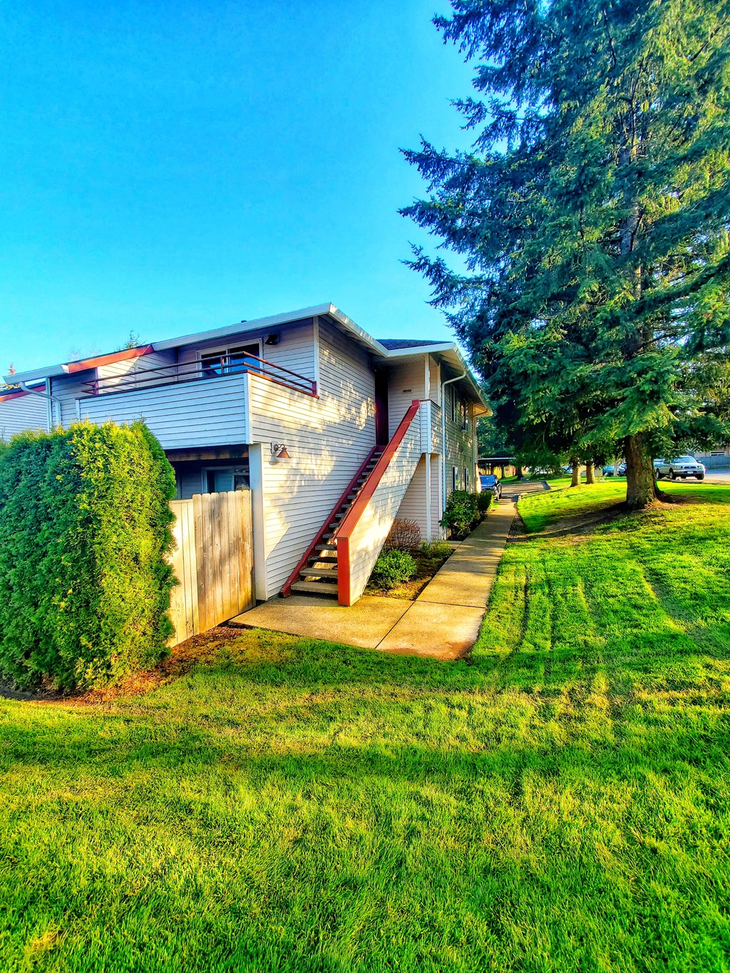 a house with a porch and a sidewalk in front of it