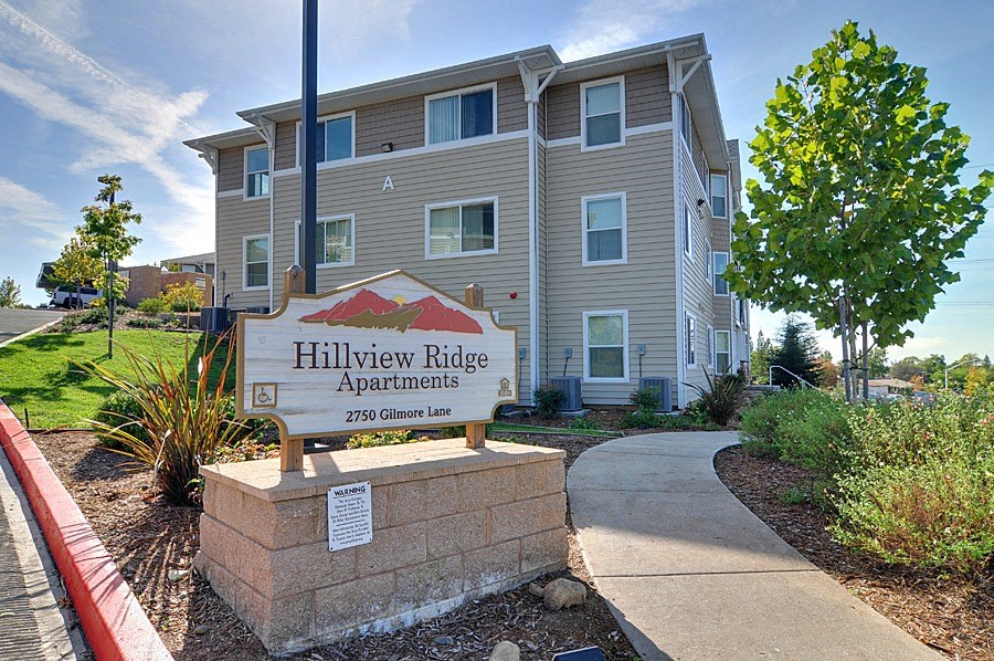an apartment building with a sign for hillview ridge apartments