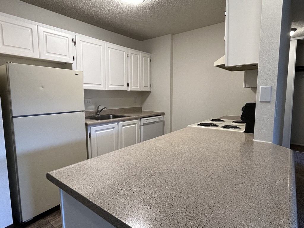 a kitchen with white cabinets and white appliances